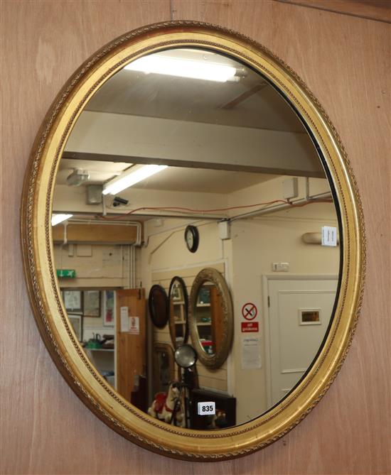 An Edwardian oval carved wood and gilt gesso wall mirror H.86cm